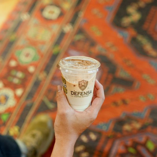 Defensa Coffee in hand
